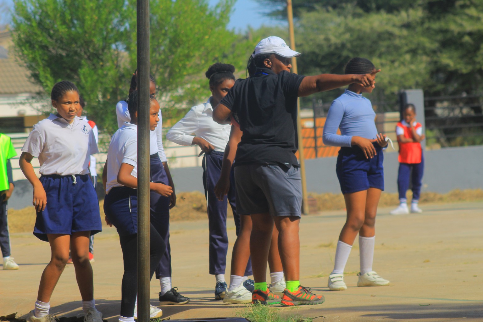 A coach directing young athletes during a training session