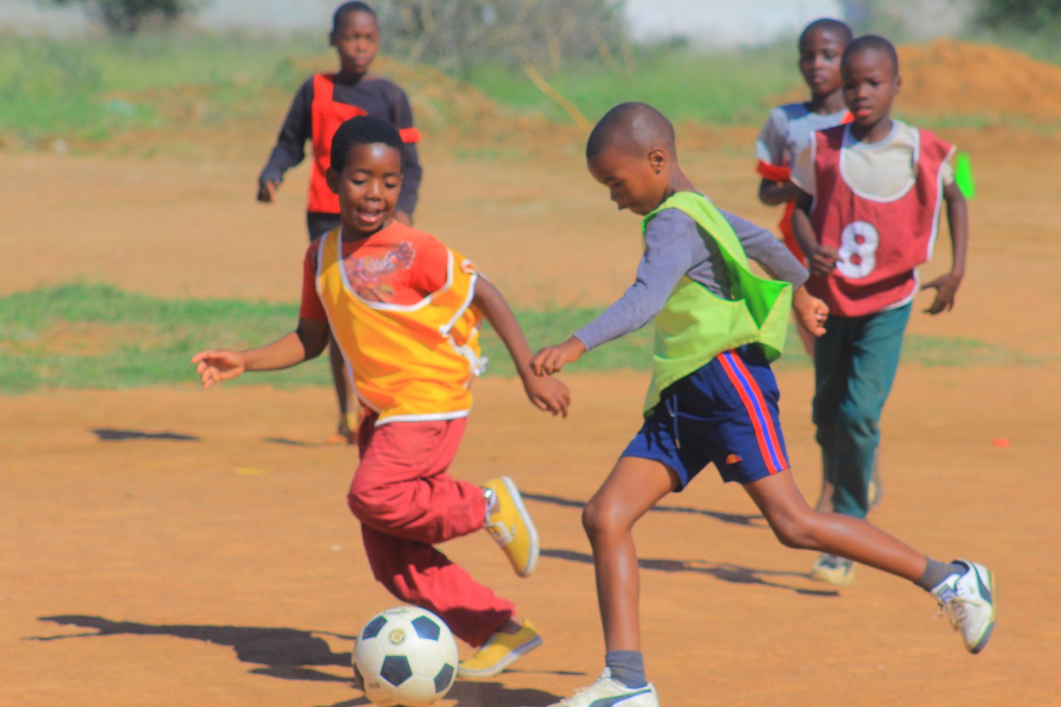 Children playing football during a youth sports activity